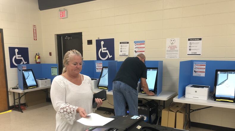 Cathy Watkins of Cartersville inserts her printed-out ballot into a scanner Thursday after voting on Georgia’s new voting machines. Voters in six counties across the state, including Bartow County and its city of Cartersville, are testing the new voting system in this fall’s elections. Voters across Georgia will use the machines in the March 24 presidential primary. MARK NIESSE / MARK.NIESSE@AJC.COM