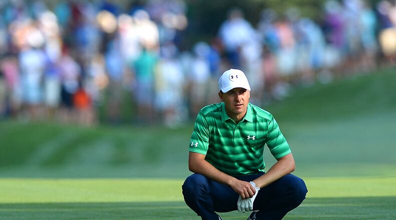 Jordan Spieth crouches near his ball on the first fairway during first round action of the PGA Championship at Quail Hollow Club Thursday in Charlotte. (Jeff Siner/Charlotte Observer)