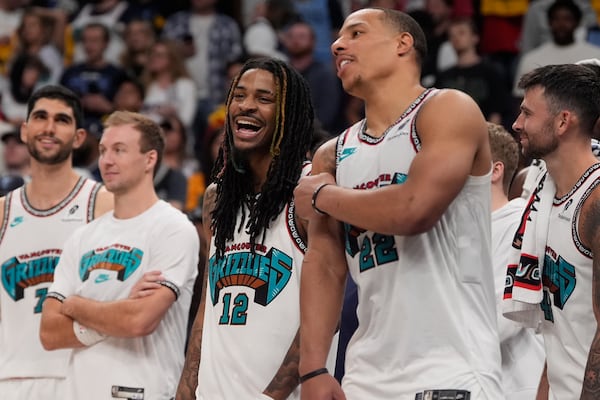 Memphis Grizzlies guard Ja Morant (12) and guard Desmond Bane (22) celebrate late in the second half of an NBA play-in tournament basketball game against the Dallas Mavericks, Friday, April 18, 2025, in Memphis, Tenn. (AP Photo/George Walker IV)