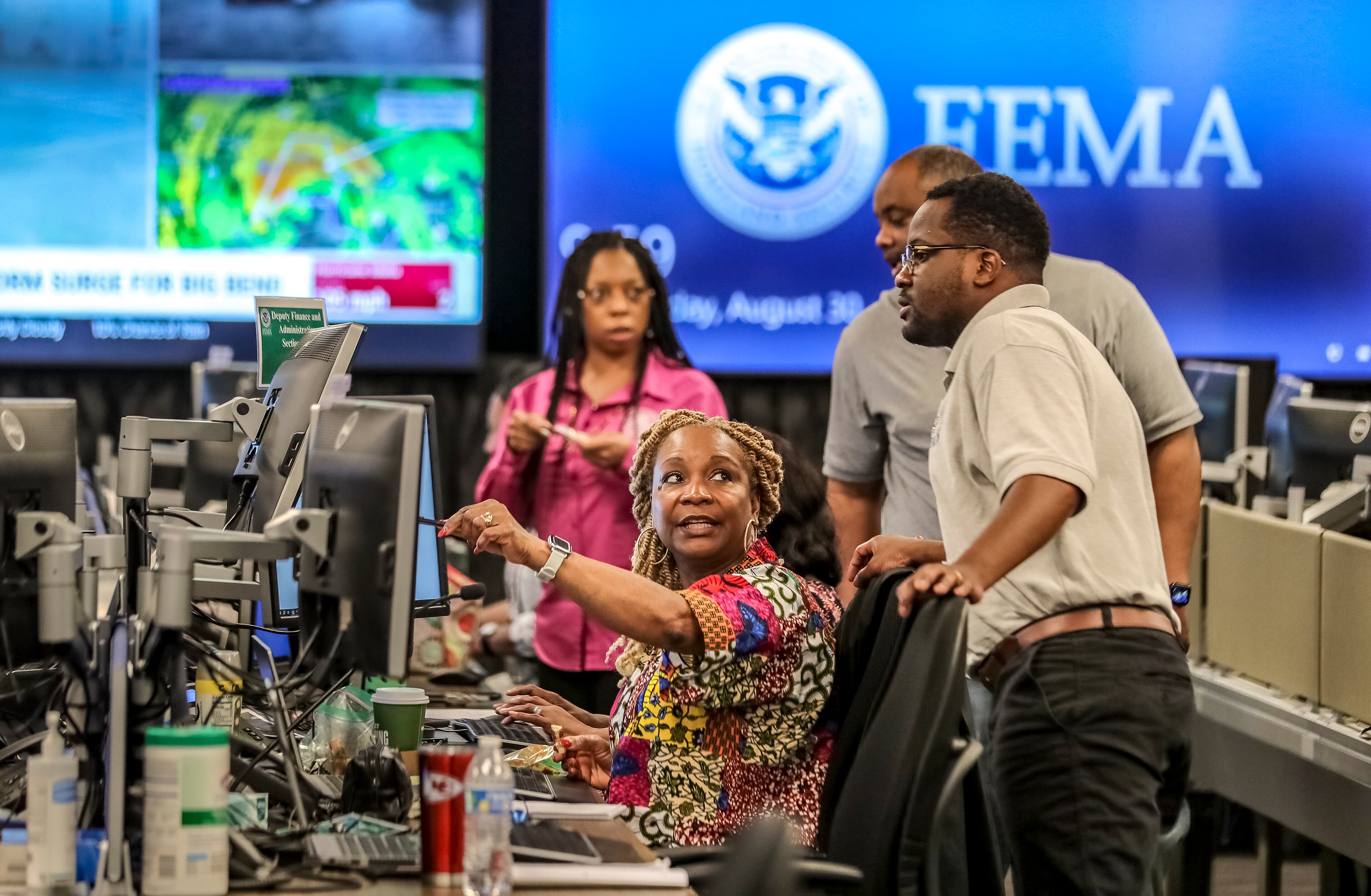 Workers discuss a situation at the FEMA Regional Response Coordination Center in DeKalb County in 2023.