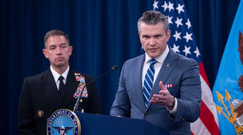Defense Secretary Pete Hegseth is joined by Adm. Brad Cooper, left, as he speaks to members of the media during a press briefing at the Pentagon, Thursday, April 16, 2026 in Washington. (AP Photo/Kevin Wolf)