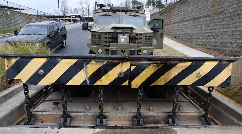 A photo from Ervin Lee Bolling's federal arrest affidavit shows damage to the FBI Atlanta office's final denial barrier just inside its gate.