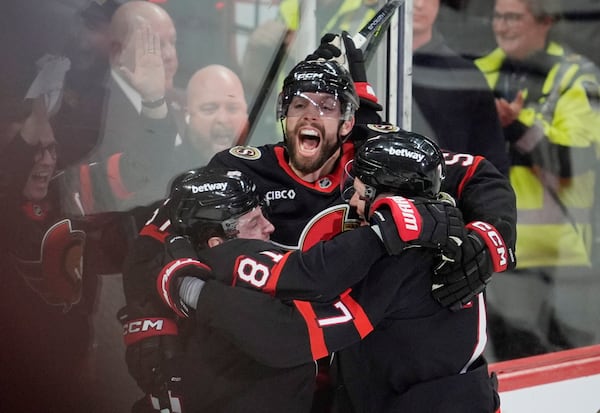 Ottawa Senators' David Perron (57) celebrates his goal with Adam Gaudette (81) and Brady Tkachuk (7) after scoring against the Toronto Maple Leafs during third period NHL playoff action in Ottawa, Saturday, April 26, 2025. (Adrian Wyld/The Canadian Press via AP)