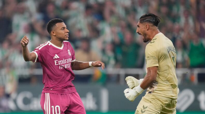 Real Madrid's Kylian Mbappe, left, reacts after missing a penalty kick in front of Betis' goalkeeper Alvaro Valles during the Spanish La Liga soccer match between Real Betis and Real Madrid in Seville, Spain, Friday, Sept. 4, 2026. (AP Photo/Jose Breton)