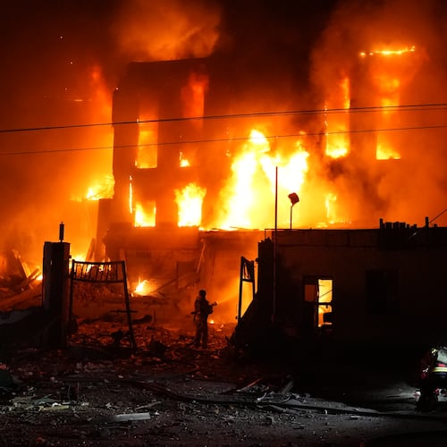 A rescue worker puts out a fire of a building destroyed after a Russian missile attack in Kyiv, Ukraine Tuesday, Sept. 8, 2026. (AP Photo/Alex Babenko)