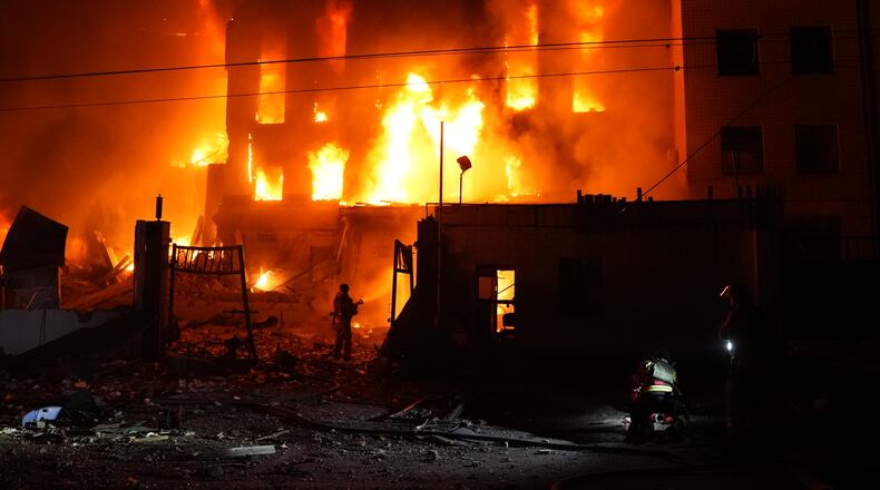 A rescue worker puts out a fire of a building destroyed after a Russian missile attack in Kyiv, Ukraine Tuesday, Sept. 8, 2026. (AP Photo/Alex Babenko)