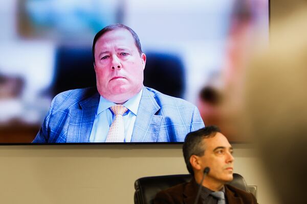 Georgia Public Service Commission Chairman Jason Shaw joins via a video call during a PSC meeting in Atlanta in January. Commissioner Peter Hubbard is shown in the foreground. (Abbey Cutrer/AJC)
