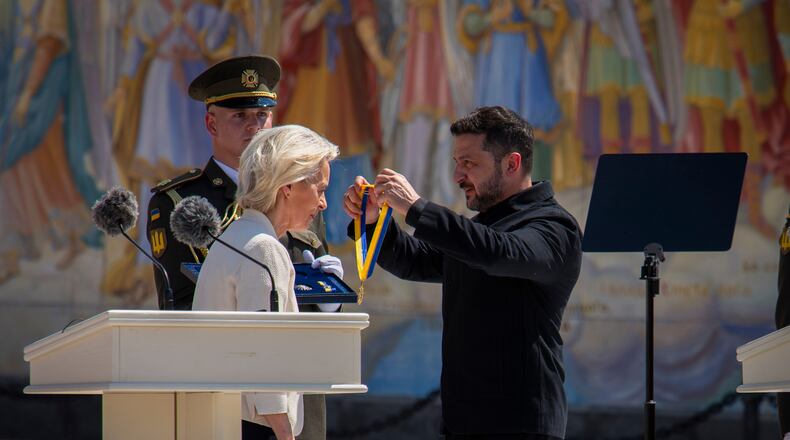 Ukrainian President Volodymyr Zelenskyy, right, awards European Commission President Ursula von der Leyen in Kyiv, Ukraine, Wednesday, July 15, 2026. (AP Photo/Dan Bashakov)