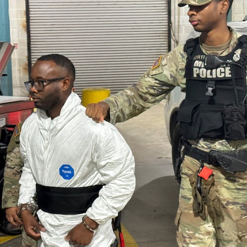Sgt. Quornelius Radford, left, is facing attempted murder charges in the shooting of five soldiers at Fort Stewart last week. Last week, he was escorted by military police into a booking room at the Liberty County Jail in Hinesville. (Lewis M. Levine/AP)