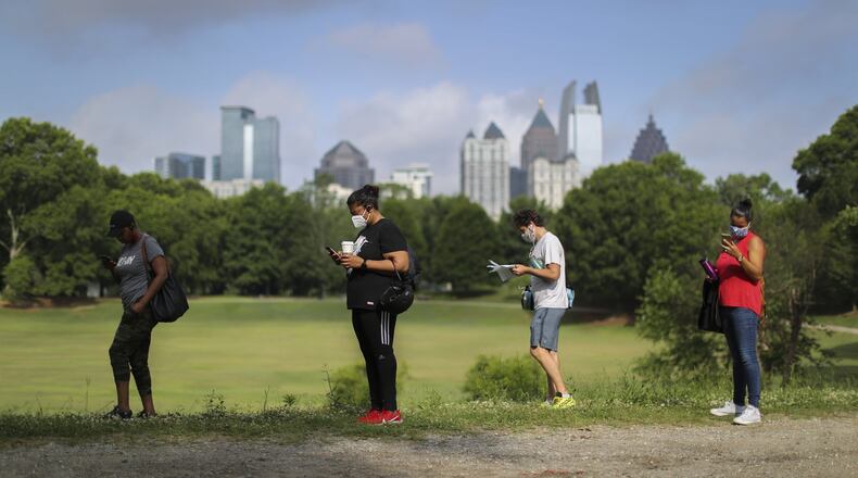 Voters wait in long lines, at times in the rain, at New Beginnings Full Gospel Church on Tuesday, June 9, 2020. The lines were taking more than 3.5 hours. This polling location opened at 7 am with only one machine of the four available working and had two of the four working at 4:30 and were not providing provisional ballots. (Jenni Girtman for The Atlanta Journal-Constitution)
