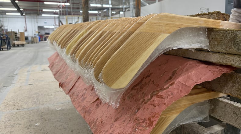 FILE - Wooden hockey sticks are stacked as they move along the assembly line at the Roustan Hockey factory, which is the last major manufacturer of hockey sticks in Canada on Aug. 27, 2025 in Brantford, Ontario. (AP Photo/Kelvin Chan, File)