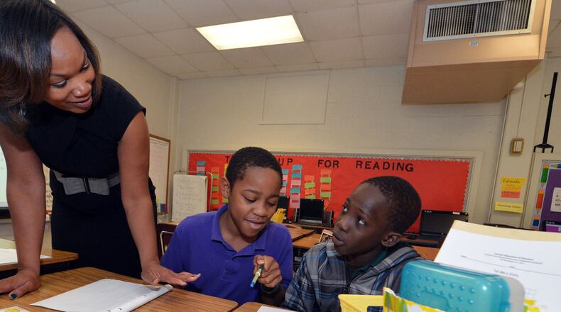 Teachers like Venetian Hills Elementary's Marie Hall (left) are among the 7,000 Atlanta Public School system employees set to earn some kind of pay increase under a proposal approved April 17, 2014, by the city school board's Budget Commission.