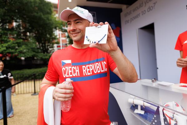 Michal Prochazka makes a custom bracelet at the Bank of America stand in the FIFA Fan Festival in Atlanta, Thursday, June 18, 2026. (Estela Muñoz/AJC)