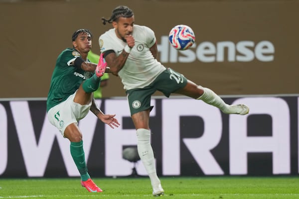 Palmeiras' Facundo Torres, left, and Chelsea's Malo Gusto fight for the ball during the Club World Cup quarterfinal soccer match between Palmeiras and Chelsea in Philadelphia, Friday, July 4, 2025. (AP Photo/Chris Szagola)