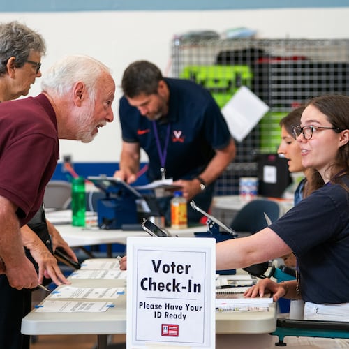Voters check in at Lyles-Crouch Traditional Academy for the Virginia primary election, Tuesday, Aug. 4, 2026, in Alexandria, Va. (AP Photo/Allison Robbert)