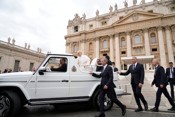 Pope Leo XIV leaves after his first weekly general audience in St. Peter's Square at The Vatican, Wednesday, May 21, 2025. (AP Photo/Gregorio Borgia)