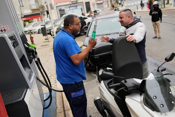 People queue for petrol in Lisbon, Tuesday, April 29, 2025, the day after a nationwide power outage that shut down gas stations, trains and subways. (AP Photo/Armando Franca)