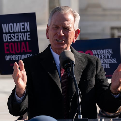 FILE - Sen. Tommy Tuberville, R-Ala., speaks to the crowd as protesters gather outside the Supreme Court as it hears arguments over state laws barring transgender girls and women from playing on school athletic teams, Jan. 13, 2026, in Washington. (AP Photo/Jose Luis Magana, File)