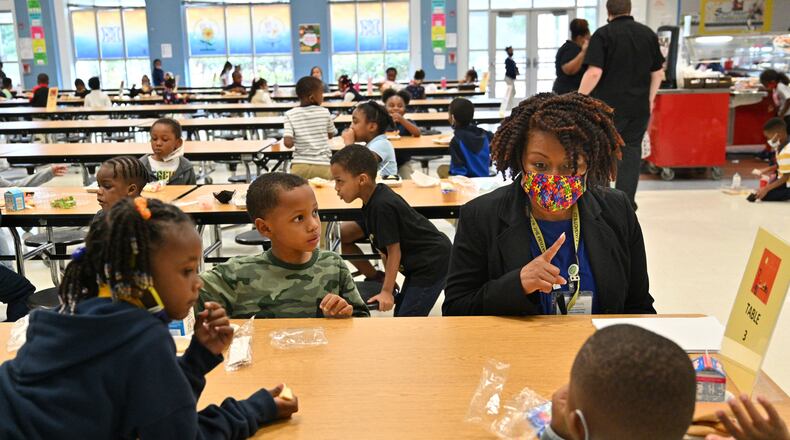Principal Miranda Freeman talks to kindergarten students at school cafeteria at Cliftondale Elementary School in College Park on Oct. 13. Many metro Atlanta school districts reported at uptick in coronavirus cases before winter break. (Hyosub Shin / Hyosub.Shin@ajc.com)