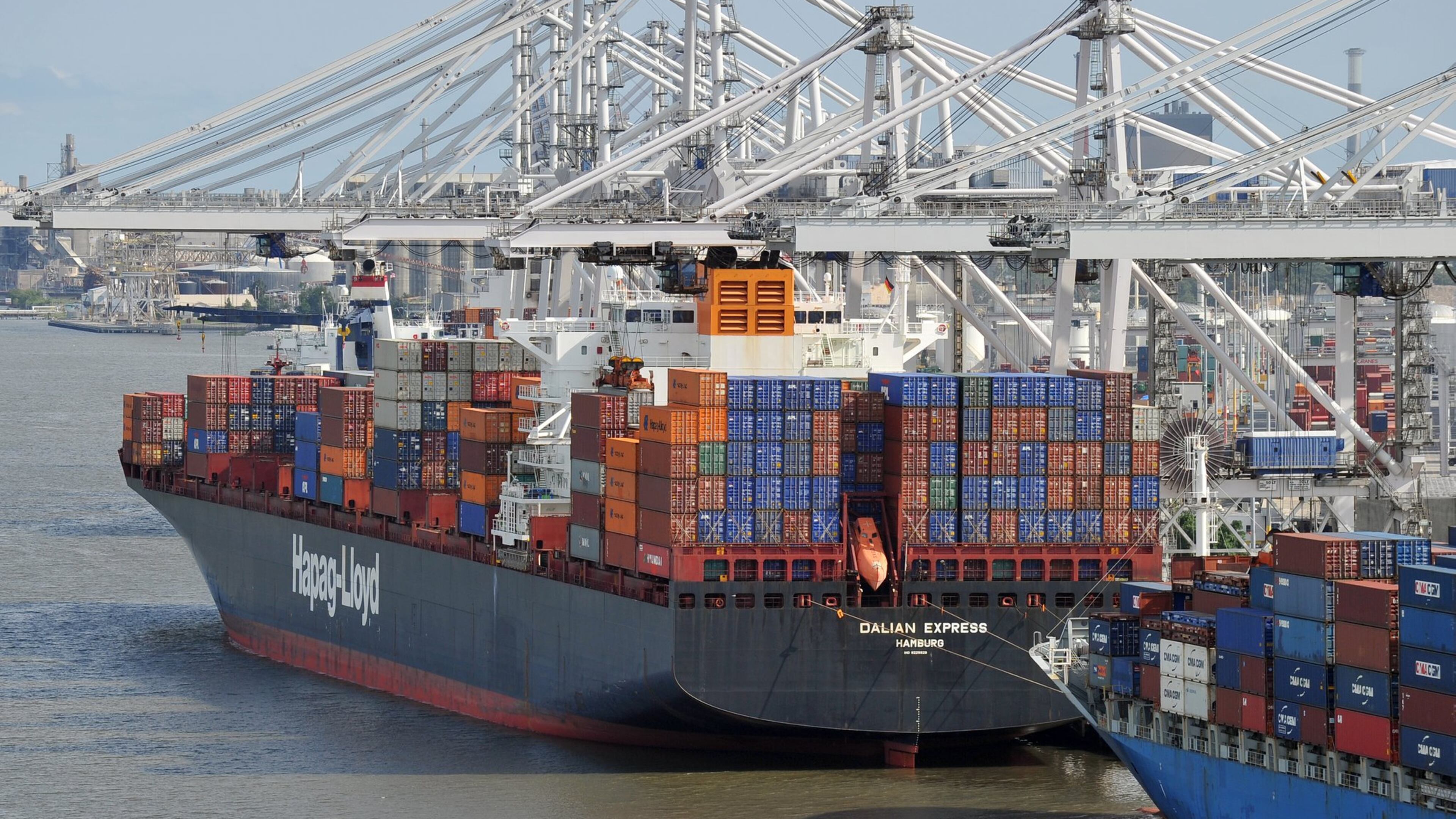 Cargo ships on their way to and from a crucial Georgia port regularly pass by downtown Savannah. (Brant Sanderlin/AJC)