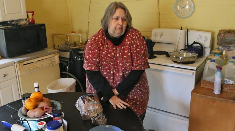 March 27, 2014 - Ball Ground - Jo Ann de la Moriniere, 73, who says she has had a lot of trouble with her food stamps, prepares lunch at her home in Ball Ground. Georgia's problem-wracked food stamp system continues to block people from getting the assistance. Much of the problem focuses on the flawed call-in center, which people use to apply and ask questions and undergo interviews. In January, nearly half of the callers could not get through. Wait times stretch over hours. The agency has a 40,000 case backlog. BOB ANDRES / BANDRES@AJC.COM