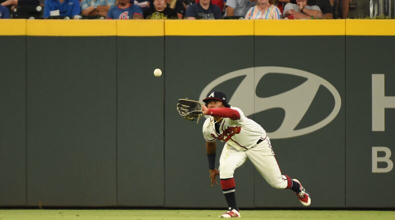 Braves' Ronald Acuna fields a ball in the fourth inning against the Los Angeles Dodgers Saturday,, Aug. 17, 2019, at SunTrust Park in Atlanta.