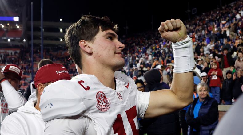 Alabama quarterback Ty Simpson celebrates after a win over Auburn in an NCAA college football game, Saturday, Nov. 29, 2025, in Auburn, Ala. (AP Photo/Butch Dill)