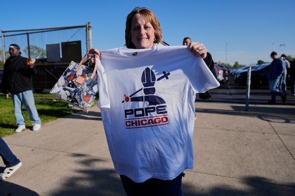 Sue Rosinski holds a Pope Leo XIV-themed shirt she bought outside Rate Field before a baseball game between the Chicago White Sox and Miami Marlins, Saturday, May 10, 2025, in Chicago. (AP Photo/Erin Hooley)