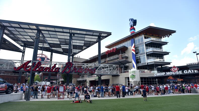 Fans wait in line to get into SunTrust Park before the Braves’ game against the Milwaukee Brewers on Aug. 10.