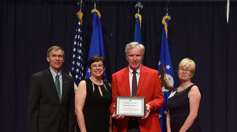Richard Isaacks (red jacket) received the 2017 Director’s Award for Volunteer of the Year for his dedication and excellence in serving the National Museum of the U.S. Air Force. Posing with Isaacks are (from left to right) Museum Director retired Lt. Gen. Jack Hudson, Air Force Materiel Command Executive Director Patricia M. Young and Air Force Museum Foundation Board of Trustees President retired Col. Susan E. Richardson. (U.S. Air Force photo)