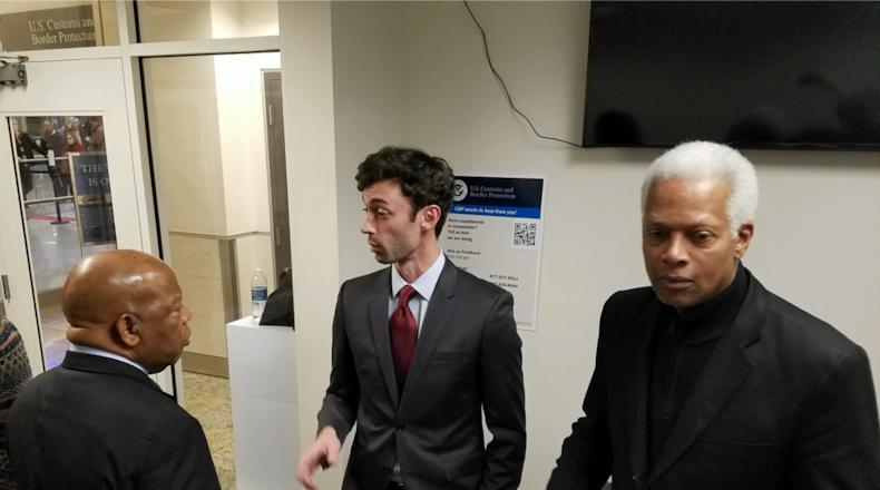 Jon Ossoff, center, is flanked by Georgia Reps. John Lewis and Hank Johnson at Atlanta's airport.