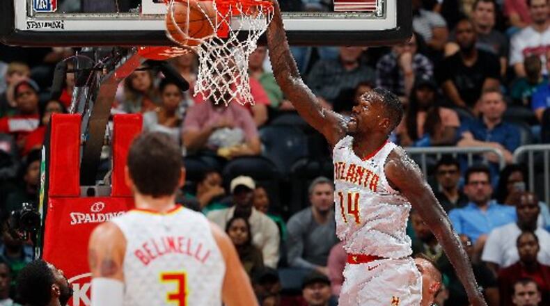 It's more than just dunks for Hawks center Dewayne Dedmon. (Kevin C. Cox/Getty Images)