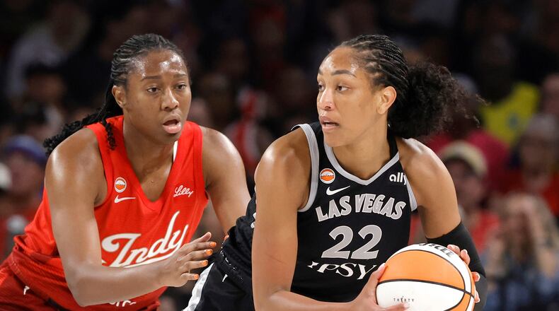 Indiana Fever center-forward Aliyah Boston, left, defends against Las Vegas Aces center A'ja Wilson (22) during the first half of an WNBA basketball game Sunday, July 12, 2026, in Las Vegas. (Steve Marcus/Las Vegas Sun via AP)
