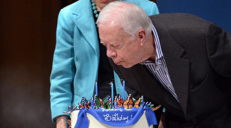 Former President Jimmy Carter blows out the candles on his cake during his 90th birthday celebration in October 2014.
HYOSUB SHIN / HSHIN@AJC.COM