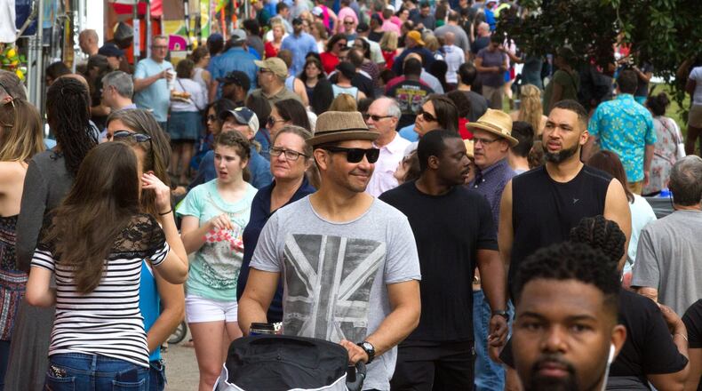 A large crowd walks past the food and artist booths during the 82nd Annual Atlanta Dogwood Festival in Piedmont Park. STEVE SCHAEFER / SPECIAL TO THE AJC