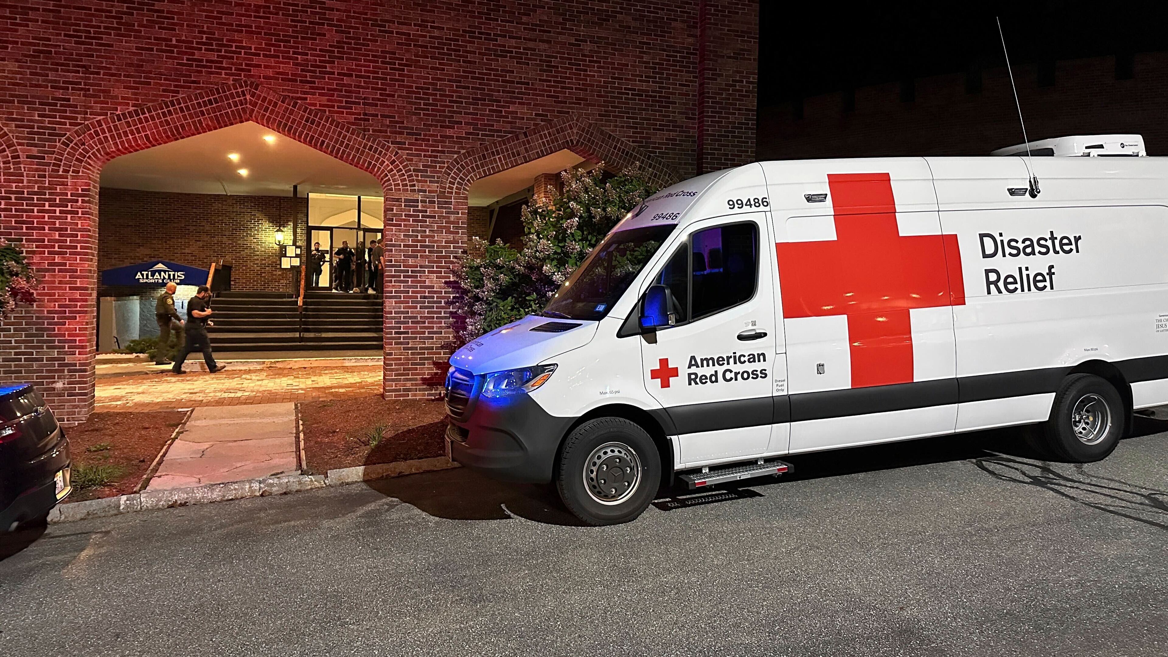 An American Red Cross Disaster Relief van is parked outside a hotel that is acting as a reunification center after a shooting at a country club in Nashua, New Hampshire, Saturday, Sept. 20, 2025. (AP Photo/Michael Casey)