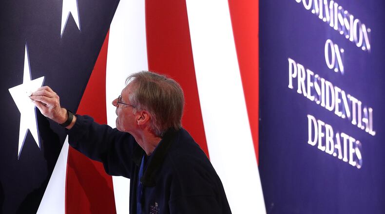 FARMVILLE, VA - OCTOBER 03: Stage worker Michael Foley cleans the set for the vice presidential debate scheduled to be held at Longwood University October 3, 2016 in Farmville, Virginia. Republican vice presidential candidate Mike Pence is scheduled to debate Democratic vice presidential candidate Tim Kaine in the first and only vice presidential debate.