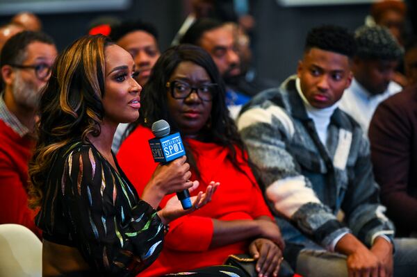 Dr. Contessa Metcalfe (with microphone) speaks during a community event about ending the HIV epidemic in Black communities at the Gathering Place in Atlanta Thursday, Dec. 1, 2022. (Daniel Varnado/For the AJC)