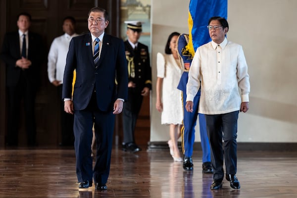 Philippine President Ferdinand "Bongbong" Marcos Jr.. right, stands beside Japan's Prime Minister Shigeru Ishiba during the singing of the national anthem at the Malacanang palace in Manila, Tuesday, April 29, 2025. (Eloisa Lopez/Pool photo via AP)