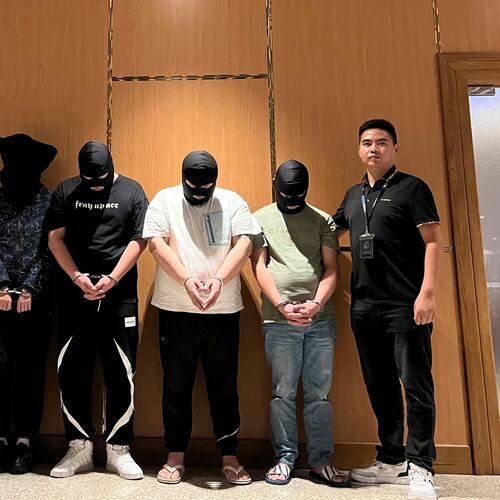 FILE - In this photo released by Xinhua News Agency, Myanmar police hand over five telecom and internet fraud suspects to Chinese police at Yangon International Airport in Yangon, Myanmar, Aug. 26, 2023. (Chinese embassy in Myanmar/Xinhua via AP)