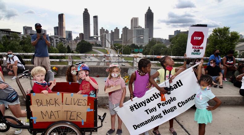 A protest group calling themselves the Tiny Activists marched to the Jackson Street bridge to lay flowers as demonstrations continued in metro Atlanta Sunday. Protests over the death of George Floyd in Minneapolis police custody continued around the United States, as his case renewed anger about others involving African Americans, police and race relations. (Photo: Steve Schaefer for The Atlanta Journal-Constitution)