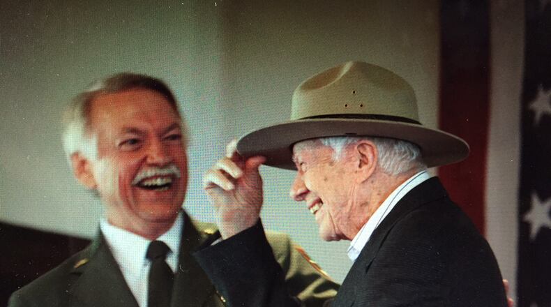 National Park Service director Jonathan B. Jarvis gives Jimmy Carter his very own iconic ranger hat Sunday during a ceremony in Plains where the former president was made an honorary national park ranger. Photo by Jill Stuckey