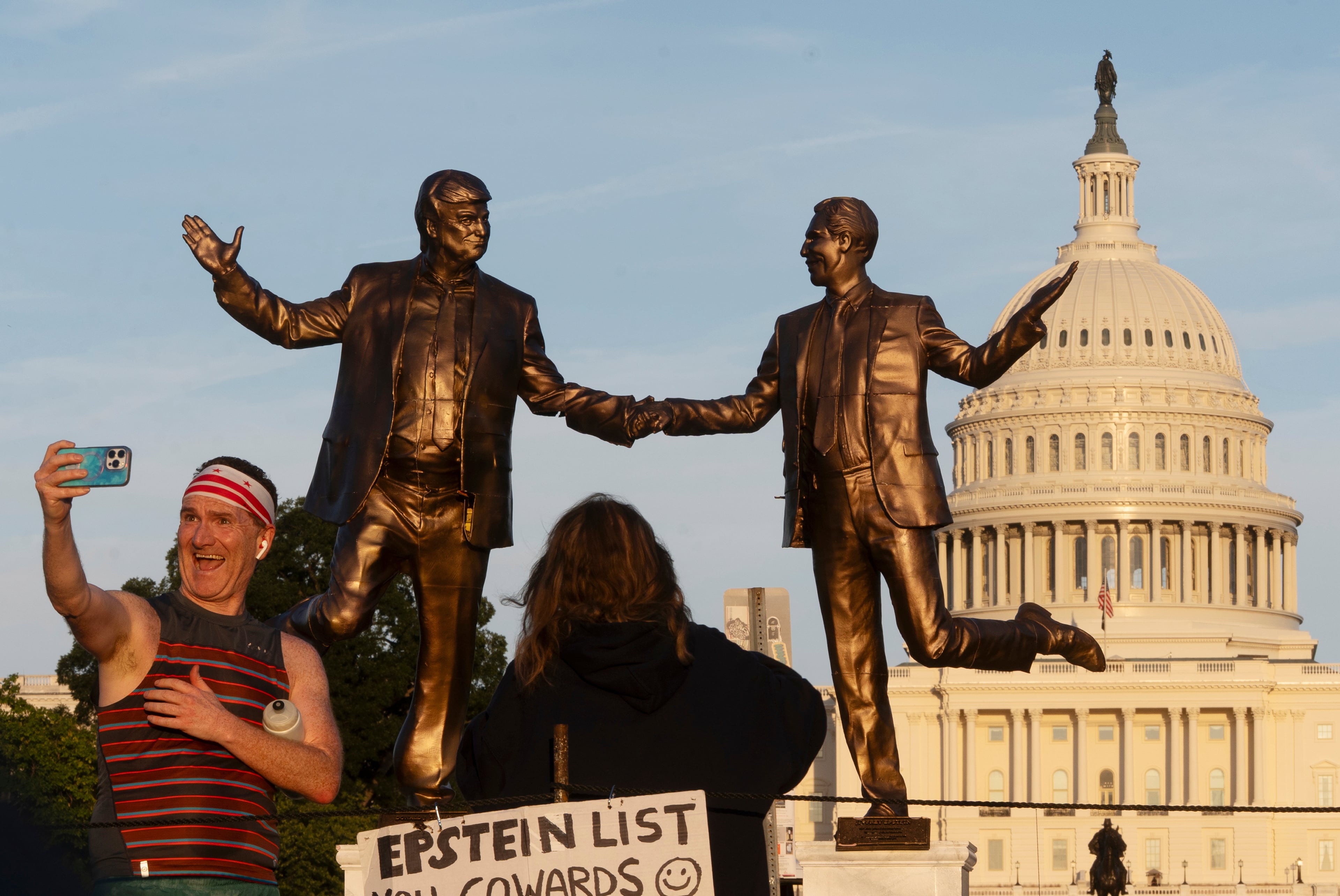 A statue depicting President Donald Trump (left) and the late Jeffrey Epstein holding hands was temporarily placed on the National Mall in Washington earlier this month by an anonymous group. (Manuel Balce Ceneta/AP)