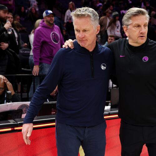 Golden State Warriors head coach Steve Kerr, left, and Minnesota Timberwolves head coach Chris Finch, right, talk after an NBA basketball game Sunday, Jan. 25, 2026, in Minneapolis. (AP Photo/Matt Krohn)