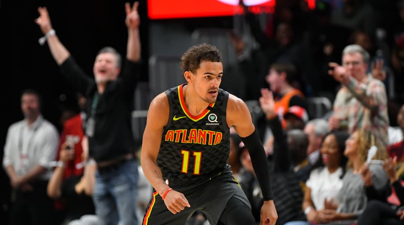 Fans cheer as Atlanta Hawks guard Trae Young turns upcourt afetr scoring against the Charlotte Hornets Monday, March 9, 2020, at State Farm Arena in Atlanta.