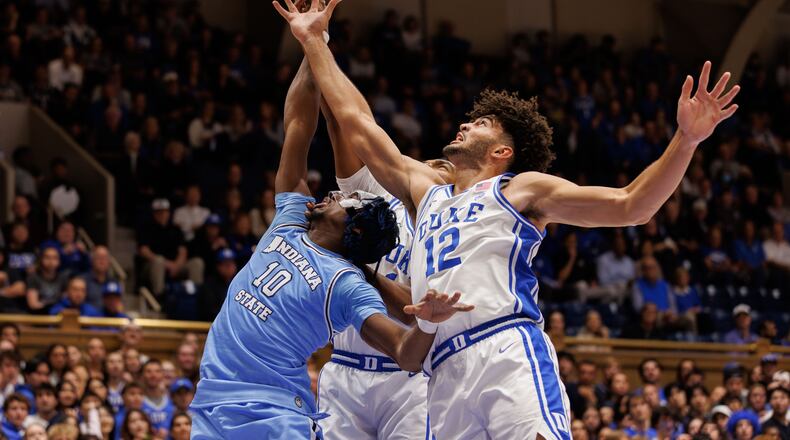 Duke's Cameron Boozer (12) and Indiana State's Enel St. Bernard (10) battle for a rebound during the first half of an NCAA college basketball game in Durham, N.C., Friday, Nov. 14, 2025. (AP Photo/Ben McKeown)