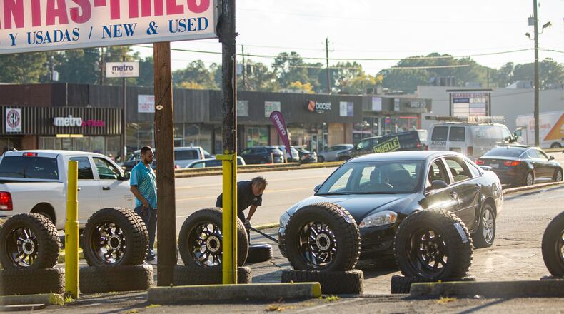 The Mableton area is considering becoming a formal city. William Wilson, a cityhood supporter and member of the South Cobb Alliance and Mableton Yes group (not pictured) points out code violations at businesses along Veterans Memorial Highway including tires being changed too close to the highway, condemned buildings that have never been demolished and automotive repair shops spilling onto the roads next to an area where new housing complexes are being built on Thursday, Oct. 13, 2022. Wilson is among the group working to create the city with the hope that the area can grow and provide better services to the residents. (Jenni Girtman for The Atlanta Journal-Constitution)