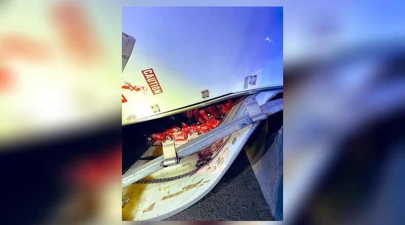 Authorities shut down the exit ramp from the southbound Downtown Connector to I-20 East after a truck hauling cans of Coca-Cola overturned early Tuesday morning, according to the Atlanta Fire Rescue Department.