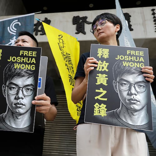 Hong Kong activist and supporters hold signs during a press event to support pro-democracy activist Joshua Wong in Taipei, Taiwan, Wednesday, Sept. 2, 2026. (AP Photo/Chiang Ying-ying)