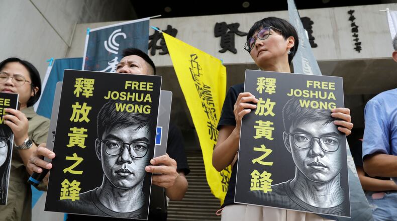 Hong Kong activist and supporters hold signs during a press event to support pro-democracy activist Joshua Wong in Taipei, Taiwan, Wednesday, Sept. 2, 2026. (AP Photo/Chiang Ying-ying)